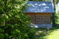 Rustic bath house with Windows made of laminated veneer lumber. Warm summer weather. Green lawn near the house. Decorative Christm Royalty Free Stock Photo