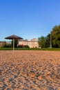 Rustic beach outskirts poor space with poor umbrella and background outskirts suburban view of simple building block architecture