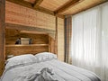 Rustic bedroom interior with wooden wainscoting