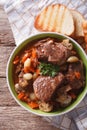 Rustic Beef Bourguignon in a bowl on a table close-up. vertical Royalty Free Stock Photo
