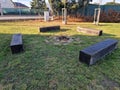 rustic bench made of halved debarked logs with legs made of logs. Royalty Free Stock Photo