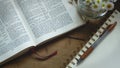 Rustic Bible on a Wooden Background with Notepad and Flowers