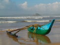 Rustic fishing boat with one outrigger in the afternoon light at Talala Beach in Sri Lanka Royalty Free Stock Photo