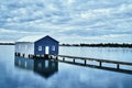 Rustic blue house on the water Royalty Free Stock Photo