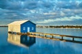 Rustic blue house on the water Royalty Free Stock Photo