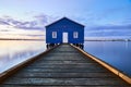 Rustic blue house on the water Royalty Free Stock Photo