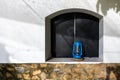 Rustic blue lantern in an exterior window, stucco and stone walls, Arusha, Tanzania Royalty Free Stock Photo