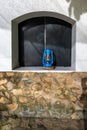 Rustic blue lantern in an exterior window, stucco and stone walls, Arusha, Tanzania Royalty Free Stock Photo