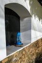 Rustic blue lantern in an exterior window, stucco and stone walls, Arusha, Tanzania Royalty Free Stock Photo