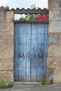 Rustic blue old wooden door with tiled roof Royalty Free Stock Photo