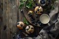 Rustic blueberry muffins with coffee and milk, overhead shot with space for text, cozy setting Royalty Free Stock Photo