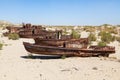 Rustic boats on a ship graveyards on a desert around Moynaq, Muynak or Moynoq - Aral sea or Aral lake - Uzbekistan in Central Asia Royalty Free Stock Photo