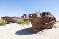 Rustic boats on a ship graveyards on a desert around Moynaq, Muynak or Moynoq - Aral sea or Aral lake - Uzbekistan in Central Asia Royalty Free Stock Photo