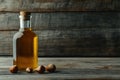 Rustic bottle of hazelnut oil with scattered hazelnuts on a wooden backdrop Royalty Free Stock Photo