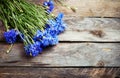 Rustic bouquet of blue cornflowers on vintage wooden board