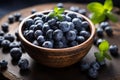 A rustic bowl holds a harvest of juicy blueberries, beautifully adorned