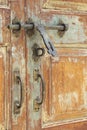 Rustic Brass Door Handles and Bolt on Old Wooden Door Royalty Free Stock Photo