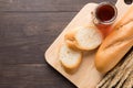 Rustic bread or baguette with honey on the wooden background Royalty Free Stock Photo