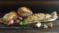 Rustic bread and fresh fish arrangement on wood with onions and herbs Royalty Free Stock Photo