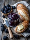 Rustic breakfast with blackberry jam, bread, and butter on a table. Royalty Free Stock Photo