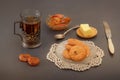 Rustic breakfast with oatmeal cookies, butter, jam and a glass of hot tea in a vintage silver cup holder Royalty Free Stock Photo