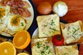 Rustic breakfast - roasted bread with butter and chives, fried eggs and bacon