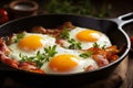 Rustic Breakfast Scene - Sizzling Bacon and Eggs in Cast Iron Skillet on Wooden Table Royalty Free Stock Photo