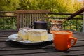 Rustic breakfast. Wooden coffee table with coffee cups, cezve, lake Bled cream cake