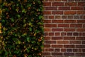 Rustic brick wall background with a Christmas garland and copy space image Royalty Free Stock Photo