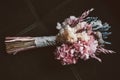 A rustic bridal bouquet on a dark background