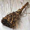 Rustic Broom Made of Twigs and Sticks Tied Together on White Fabric Background Royalty Free Stock Photo