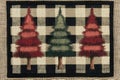 Rustic buffalo check fabric featuring three christmas trees Royalty Free Stock Photo