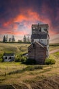 Rustic buildings and grain elevator stand in what used to be the town of Sharples Alberta Canada Royalty Free Stock Photo