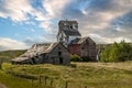 Rustic buildings and grain elevator stand in what used to be the town of Sharples Alberta Canada Royalty Free Stock Photo