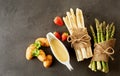 Rustic bundles of fresh green and white asparagus