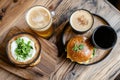 Rustic burger and beer setup with fresh greenery on wooden table Royalty Free Stock Photo