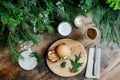 Rustic burger and beer setup with fresh greenery on wooden table Royalty Free Stock Photo