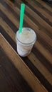 Rustic butcher block table with glass canning jar of root beer float foaming green wide mouth straw inserted Royalty Free Stock Photo