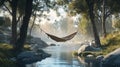 A rustic campsite by a river with a hammock tied between two trees Royalty Free Stock Photo