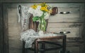 Rustic Chair with Flowers in a Vase and with Retro Lace.