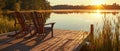Rustic Chairs On A Pier, Offering A Tranquil View Of Sunsetlit Waters