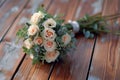 Rustic charm creamy roses, white carnations on a wooden floor