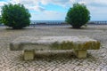 Rustic Charm: Stone Bench, Sidewalk, and Greenery. Royalty Free Stock Photo
