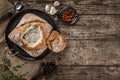 Rustic chicken soup with mushrooms in bread with spices on rustic wooden background. Royalty Free Stock Photo