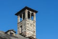 Rustic Chimney Made in Stone Against Blue Sky