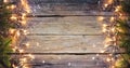 Rustic Christmas Border - Fir Branches And String Light On Old Wooden Plank