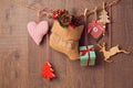 Rustic Christmas decorations hanging over wooden background
