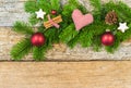 Christmas background with red heart on green fir branch with decorations on wood Royalty Free Stock Photo