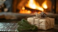 A Rustic Christmas Gift Wrapped in Brown Paper with Pine Sprigs and a Pine Cone in Front of a Fire Royalty Free Stock Photo