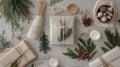 Rustic Christmas Gifts with Pine and Candles on a Grey Background Royalty Free Stock Photo